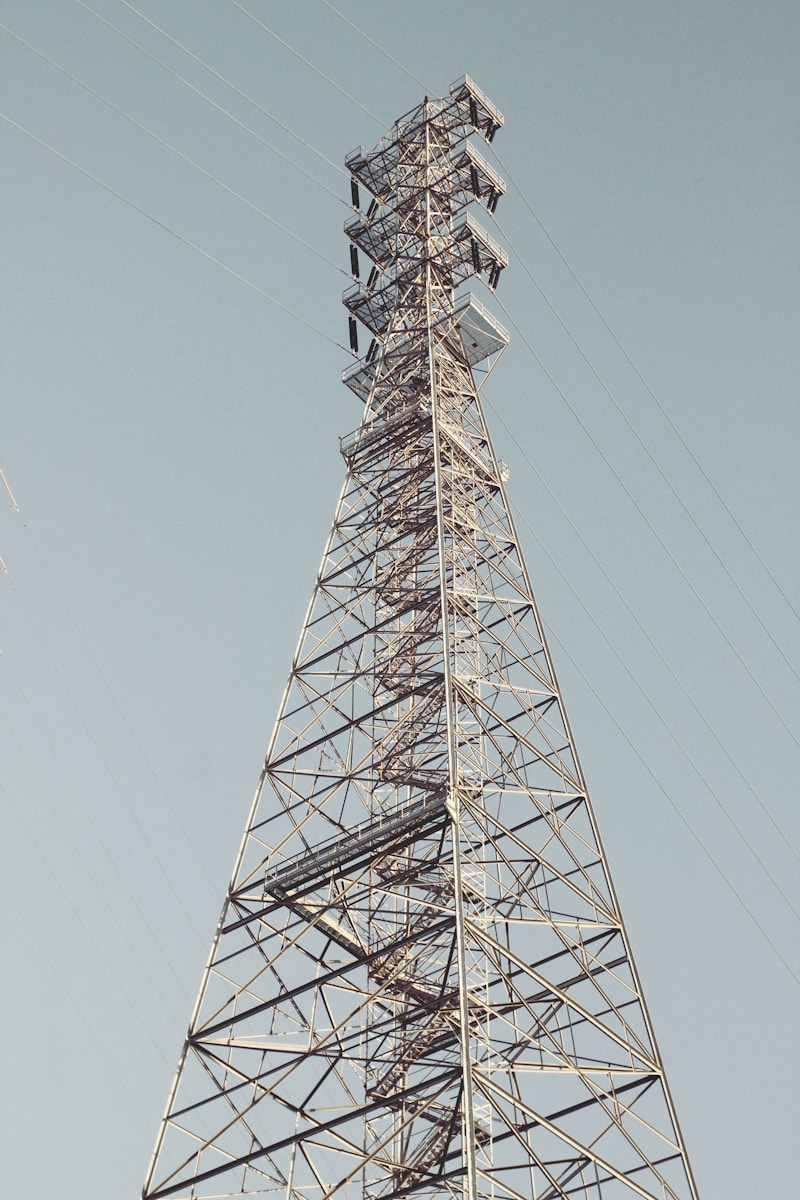 A very tall metal tower with a sky background
