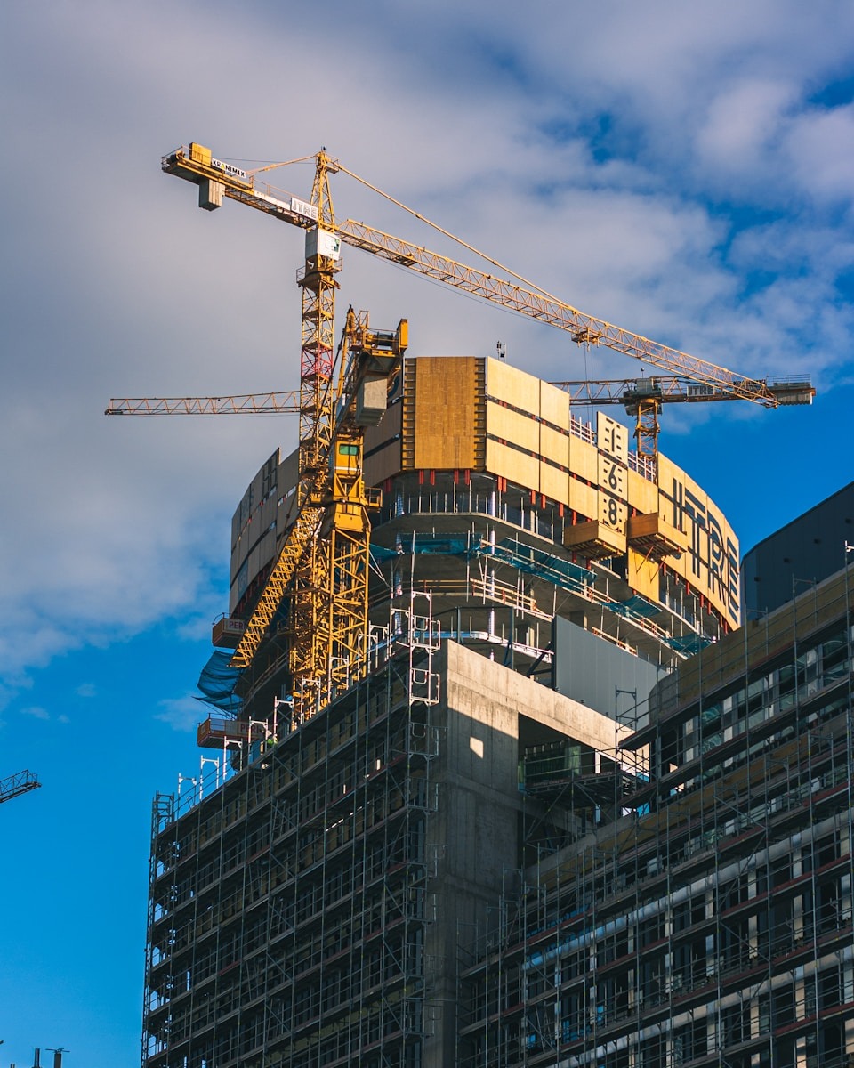 a crane is on top of a building under construction